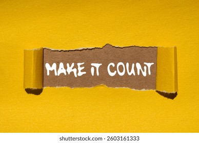 Make it count message written on ripped torn yellow paper on brown background. Conceptual make it count symbol. Copy space.