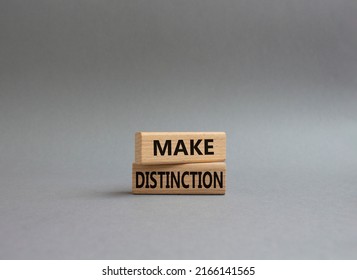 Make distinction symbol. Concept words make distinction on wooden blocks. Beautiful grey background. Business and make distinction concept. Copy space.