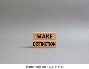 Make distinction symbol. Concept words make distinction on wooden blocks. Beautiful grey background. Business and make distinction concept. Copy space. Conceptual image