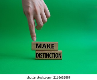 Make distinction symbol. Concept words make distinction on wooden blocks. Beautiful green background. Businessman hand. Business and make distinction concept. Copy space.. Conceptual image - Shutterstock ID 2168682889