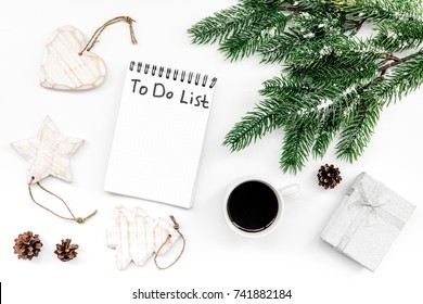 Make to do list for new year. Notebook among new year decorations on white background top view
