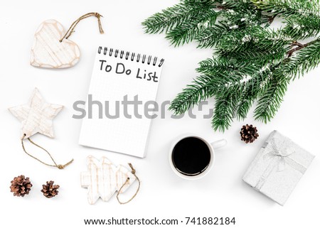 Make to do list for new year. Notebook among new year decorations on white background top view