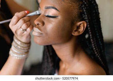 Make Up Doing Make Up To African Black Woman. Beautiful Model With Braiding.