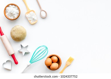 Make dough. Ingedients flour, eggs near cookware on white background top view copy space