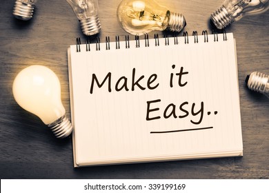 Make It Easy concept, handwriting on notebook with light bulbs