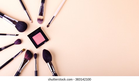 Make Up Essentials. Set Of Professional Make Up Brushes And Shadows On Light Beige Background. Place For Your Text Or Logo. Ideal For Beauty Blog. Like A Star.