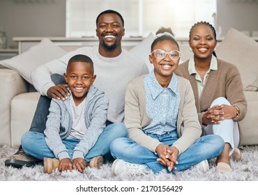 Make Family A Priority. Shot Of A Young Family Relaxing Together At Home.