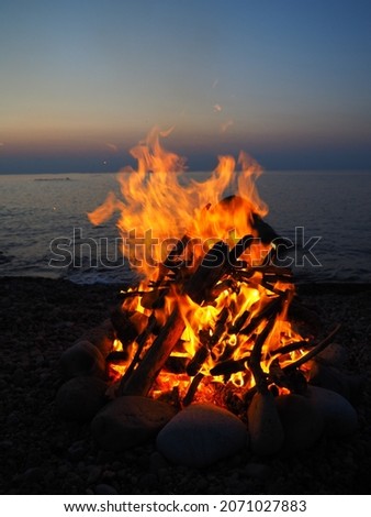 make a fire and relax by the sea at sunset Stok fotoğraf © 