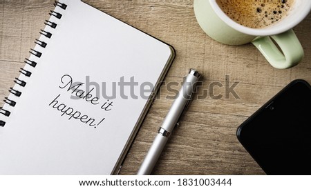 Make it happen! Flat lay. Work area with notepad, pen, cell phone and a cup of coffee. 