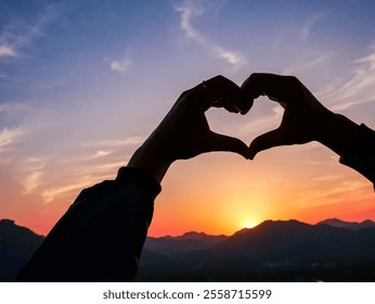 Make a heart shape with your hands in the middle of the beautiful sunset sky in west (Xihu),located in Hangzhou city of china