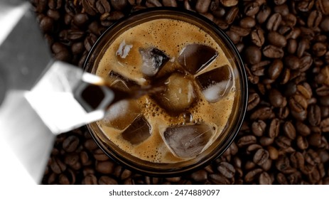 Make iced coffee. Pouring espresso in glass with ice cubes, top view - Powered by Shutterstock