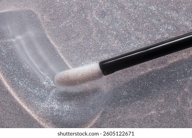Make up liquid product sample background transparent lip glossy top shimmer glitter with black stick brush 