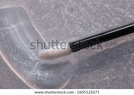 Make up liquid product sample background transparent lip glossy top shimmer glitter with black stick brush 