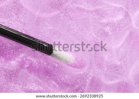 Make up liquid product sample background transparent lilac purple lip glossy top shimmer translucent glitter with black stick brush 