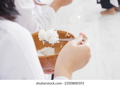 make merit, rice scoop.Thai people stand in a line to offer food to monks on the last day of Buddhist Lent. - Powered by Shutterstock