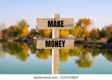 Make money message written on wooden sign with blurry nature background. Conceptual make money symbol. Copy space.