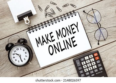 MAKE MONEY ONLINE text on an open notepad on a light table near a calculator and glasses - Shutterstock ID 2148026597