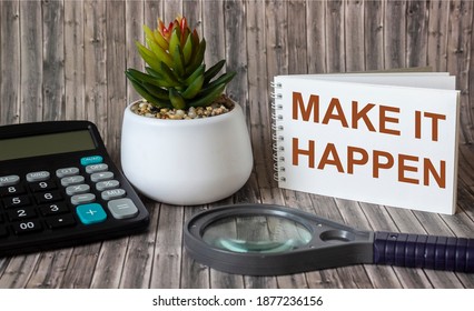 Make it possible, the phrase is written on a notebook and a wooden table. Motivational slogan.