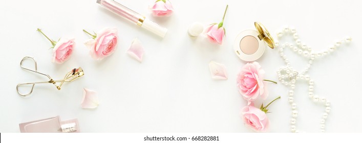 Make Up Products, Cosmetics,  Accessories And Pink Roses On White Background. Flat Lay, Top View  Feminine Desk, Workspace . Copy Space.Banner