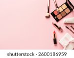 Make up products flat lay background on pink. Eyeshadow, highlighter, cream, lipsticks and cosmetic brushes.