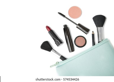 Make Up Products Spilling Out Of A Pastel Blue Cosmetics Bag, Isolated On A White Background And Blank Space At Side