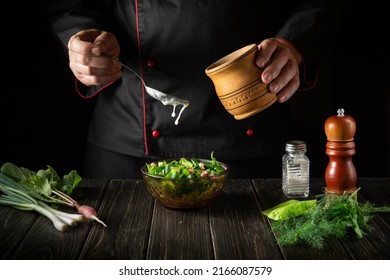 To make the salad delicious, you need to add sour cream to it. Chef preparing food in the kitchen. - Powered by Shutterstock