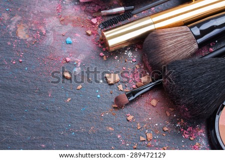 make up set, soft  makeup  brushes and  maskara on black background
