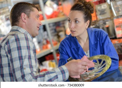 Make Showing Brake Disk To Clerk At Shop Counter