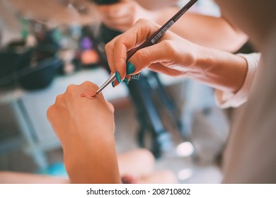 Make Up Stylist Applying Foundation On Hand