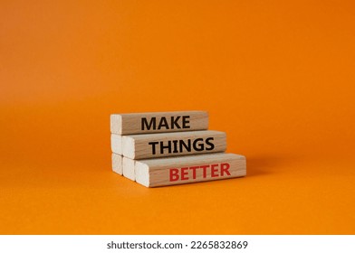Make things better symbol. Concept word Make things better on wooden blocks. Beautiful orange background. Business and Make things better concept. Copy space