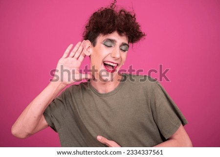 Make up. Funny drag queen posing in the studio on a pink background.