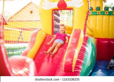  Make way, I'm about to land! Little girl playing in playground and sliding. Space for copy. - Shutterstock ID 1163108335