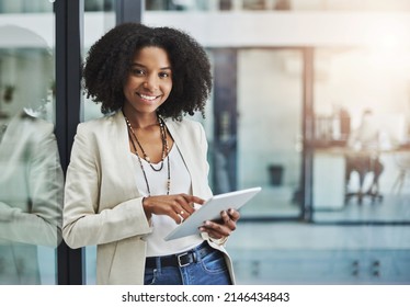 Make it your business to be tech savvy and industrious. Portrait of a young businesswoman smiling and holding a digital tablet in her office. - Shutterstock ID 2146434843