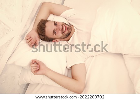 Make your sleeping environment comfortable. carefree single male seductive attitude. sexy man in bed. early morning wakeup. lazy sunday with morning sex. man lying white bedroom. time to relax