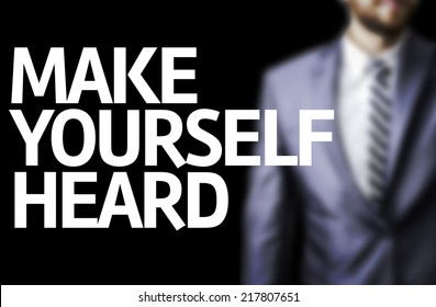 Make Yourself Heard written on a board with a business man on background