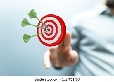 makes a dart throw on the target. The concept of persistence in business.. - Shutterstock ID 1727911753