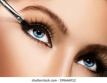 Makeup. Make-up Applying Closeup. Eyeliner. Cosmetic Eyeshadows. Eyeline Brush For Make Up. Beauty Girl With Perfect Skin. Eyelashes. Blue Eyes. Makeover 