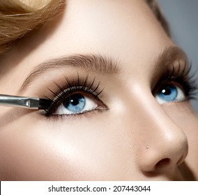 Makeup. Make-up Applying Closeup. Eyeliner. Cosmetic Eyeshadows. Eyeline Brush For Make Up. Beauty Girl With Perfect Skin. Eyelashes. Blue Eyes. Makeover 