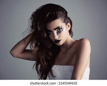 Makeup is an art and we can be artists. Studio shot of an attractive young woman wearing bold makeup.