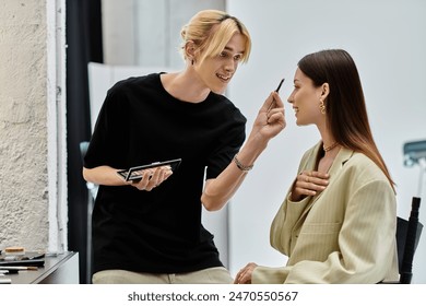 A makeup artist applies makeup to a clients face. - Powered by Shutterstock