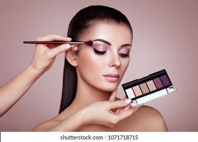 Makeup Artist Applies Eye Shadow. Beautiful Woman Face. Perfect Makeup. Make-up Detail. Beauty Girl With Perfect Skin. Nails And Manicure. Eye Shadow Palette