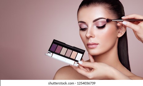 Makeup Artist Applies Eye Shadow. Beautiful Woman Face. Perfect Makeup. Make-up Detail. Beauty Girl With Perfect Skin. Nails And Manicure. Eye Shadow Palette