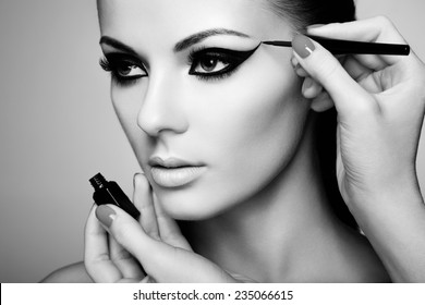 Makeup Artist Applies Eye Shadow. Beautiful Woman Face.