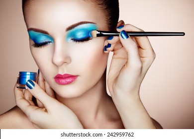 Makeup Artist Applies Eye Shadow. Beautiful Woman Face. Perfect Makeup