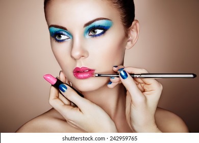 Makeup Artist Applies Lipstick. Beautiful Woman Face. Perfect Makeup