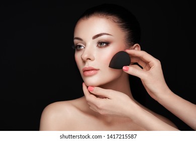 Makeup artist applies skintone. Beautiful woman face. Perfect makeup. Skincare foundation. Sponge makeup artist