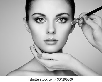 Makeup Artist Applies Skintone. Beautiful Woman Face. Perfect Makeup. Skincare Foundation. Black And White