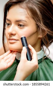 Makeup Artist Applying Cream Blush Stick Foundation On Cheek Of Young Caucasian Woman