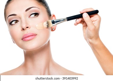 Makeup Artist Applying Liquid Tonal Foundation  On The Face Of The Woman