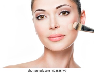 Makeup Artist Applying Liquid Tonal Foundation  On The Face Of The Woman